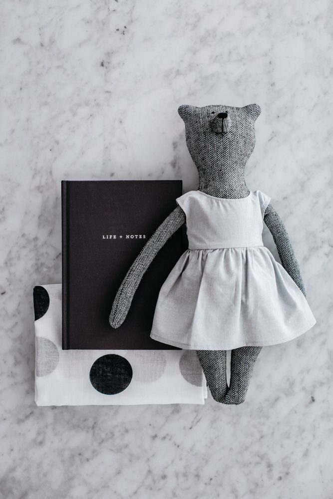 A photo of The Grace Files Bear + Life Kindness Kit showing Grace bear, our Life + Notes journal and organic muslin wrap. A unique baby shower gift.