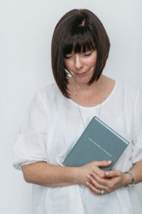 A photo of The Grace Files founder Janelle Ruthven holding a Love Letters To my Child journal
