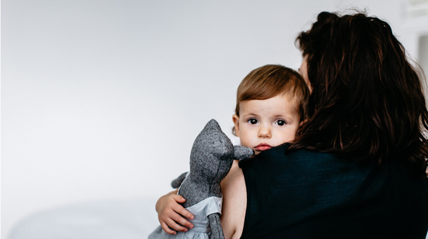 Image showing a mother holding her young daughter representing a moving blog post showcasing a mother's letter to her daughter